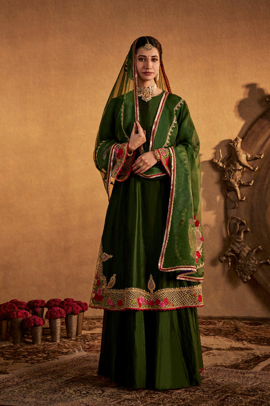 Woman in green Mughal Jaali Kalidar Set, intricately embroidered ethnic wear, full length.