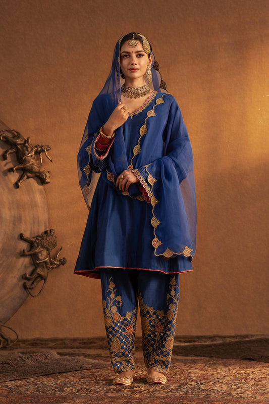 Model in a dark blue Mughal Jaali kurta set, detailed embroidery, traditional South Asian fashion, formal ethnic attire.