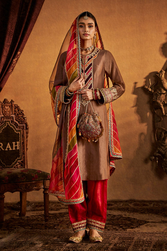 Woman in Brown-Red Kurta Set, colorful striped dupatta, traditional South Asian outfit.