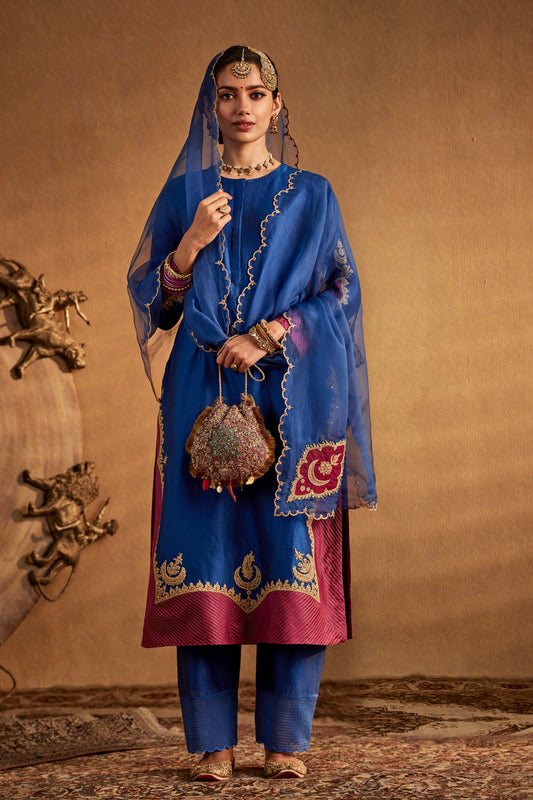 Model in a deep blue kurta set with embroidered details, traditional South Asian fashion, everyday ethnic wear, comfortable.