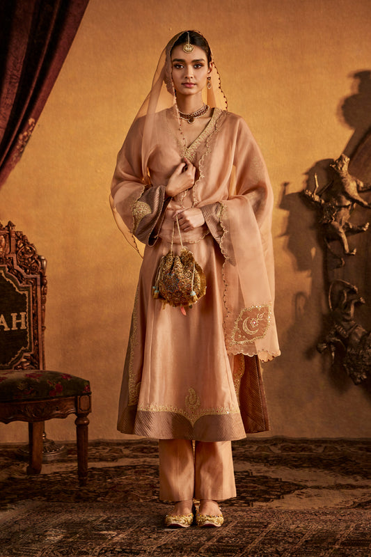 Woman in Earthy Beige Kurta Set, simple traditional South Asian attire, full length.