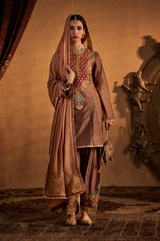 Woman in Pecan Brown Kurta Set, ornate traditional South Asian outfit, full length.