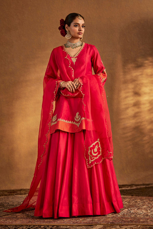 Woman in Deep Pink Sharara Set, elegant traditional South Asian formal wear, full length.