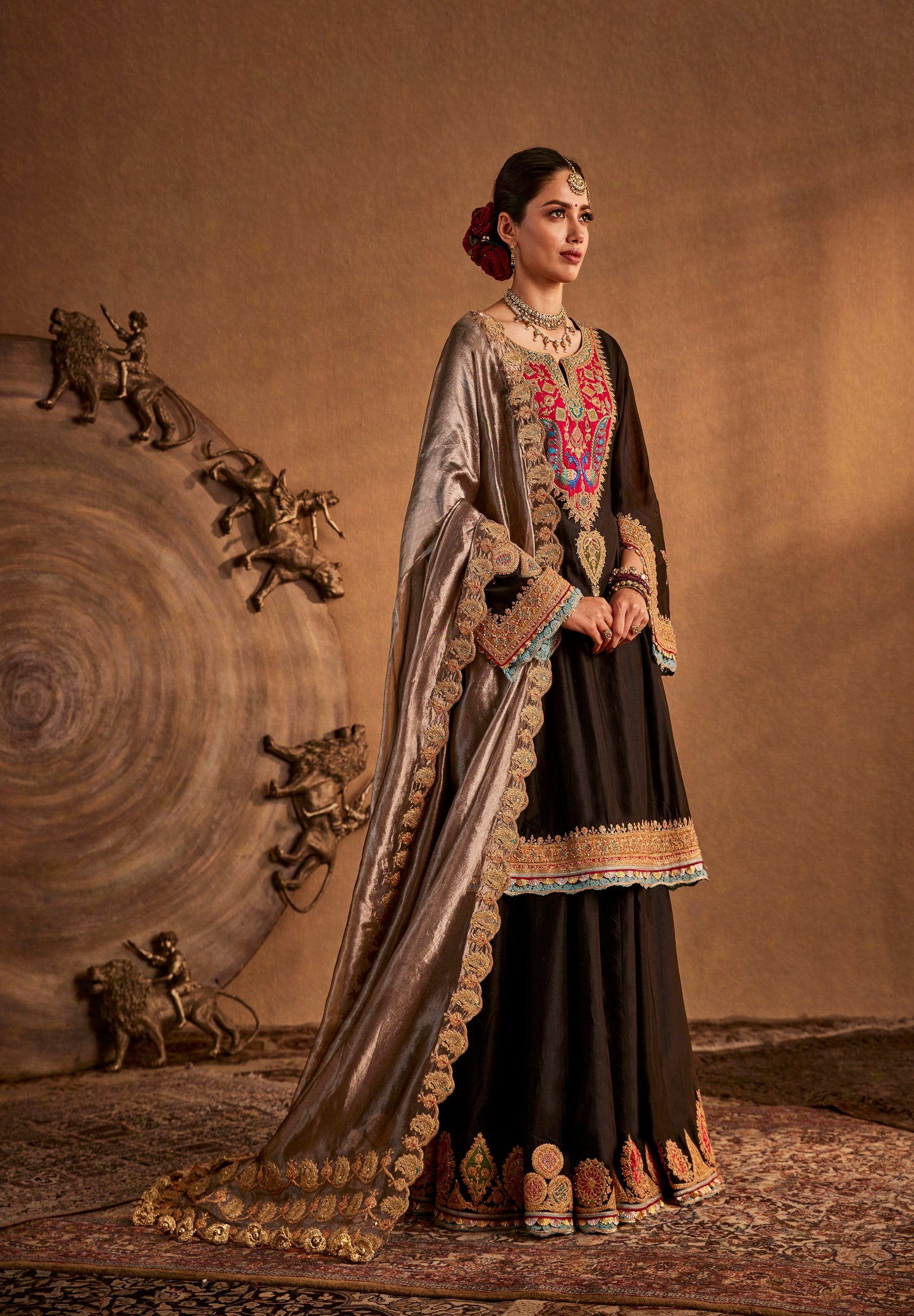 Black Rimple and Harpreet bridal lehenga with colorful embroidery and gold border, designed for statement evening weddings.