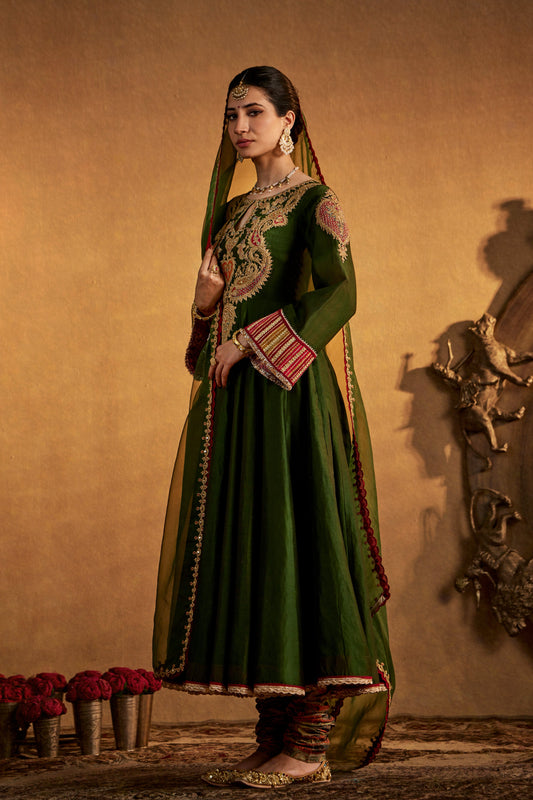 Woman in juniper green Kalidar Set, red dupatta, elegant South Asian traditional outfit.