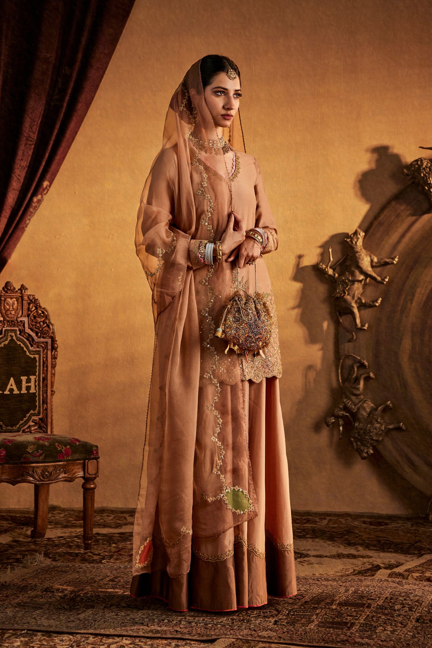 Woman in Bronze-Beige Sharara Set, embroidered ethnic wear, traditional South Asian fashion, full length.