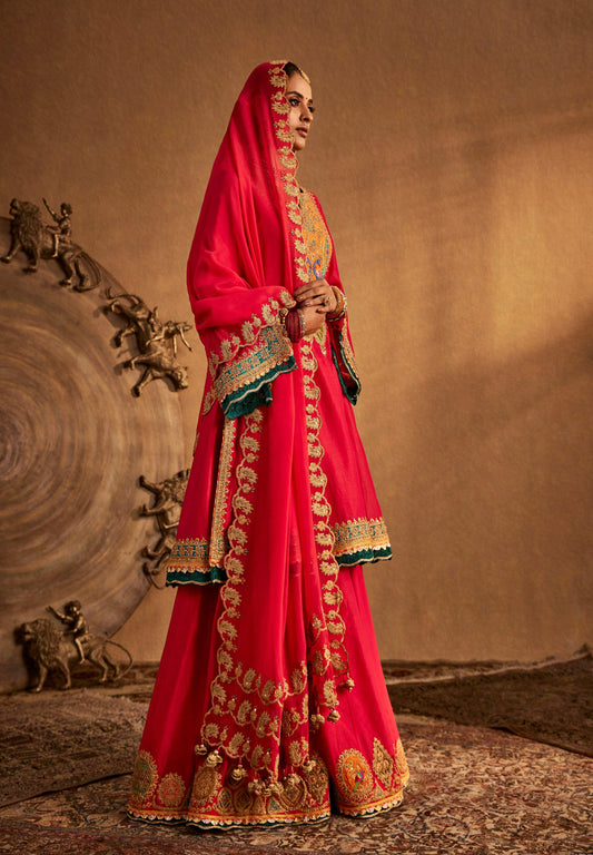 Elegant pink Rimple and Harpreet bridal lehenga with turquoise accents and zari work, ideal for Mehendi or day wedding look.