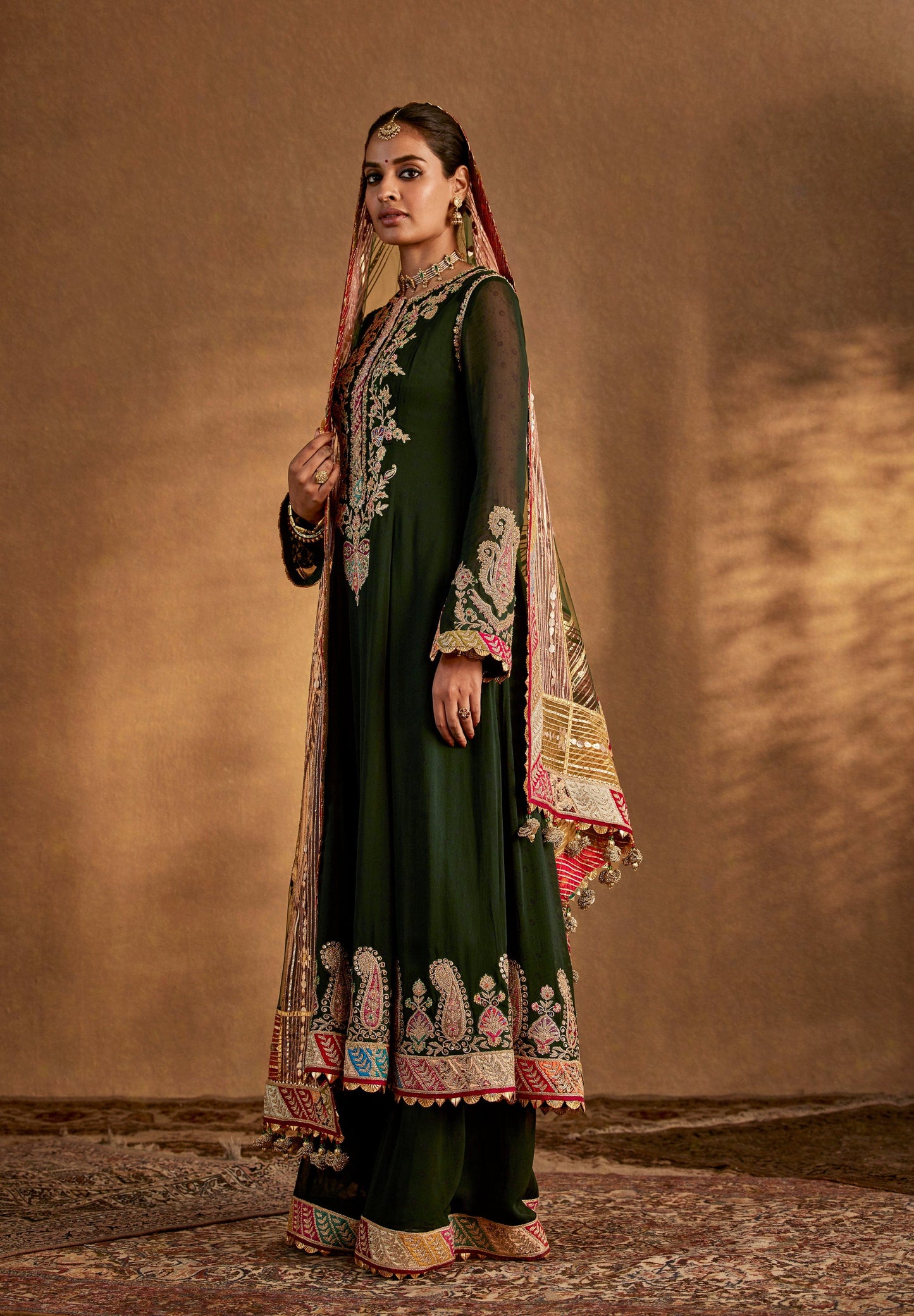 Dark green designer salwar suit with embroidered dupatta – elegant Indian ethnic wear for weddings and festive occasions.