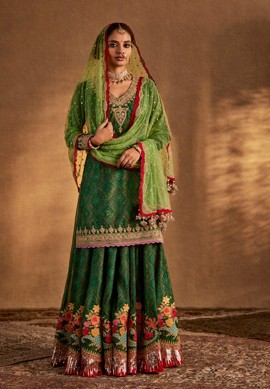Green ethnic Punjabi salwar suit with floral embroidery – festive designer outfit for weddings and traditional Indian functions.