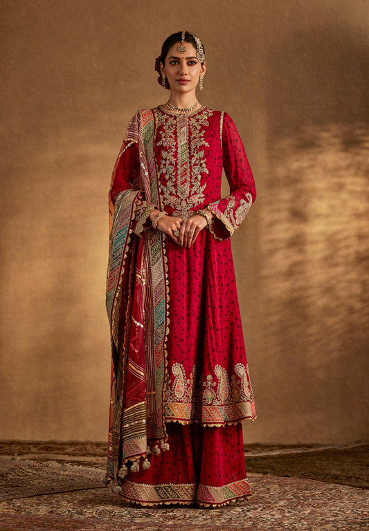Bride wearing red Rimple and Harpreet bridal lehenga with intricate zardozi work and royal dupatta for a regal bridal look.