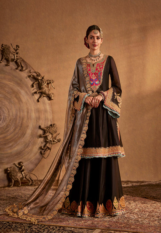 Black Rimple and Harpreet bridal lehenga with colorful embroidery and gold border, designed for statement evening weddings.