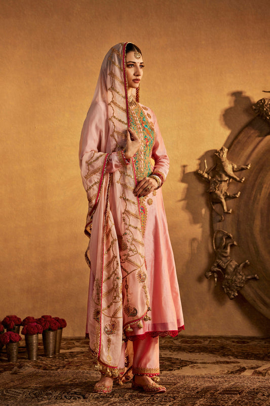 Model in a soft pink kurta set with colorful embroidered details, cultural everyday fashion, comfortable ethnic wear.